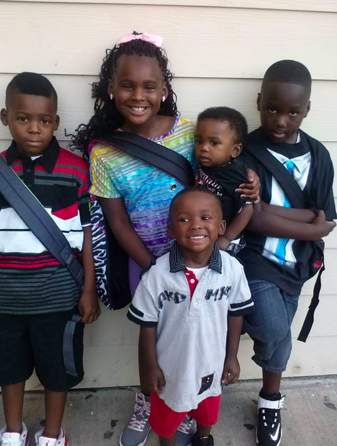Victim in apartment shooting, D.J. Maiden (far left) and his family, before the shooting: Facebook