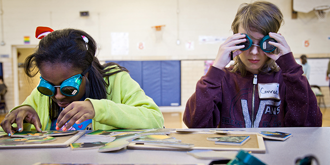 Tiara Anderson and Connor Brawley, sixth graders at Richardson's Terrace Elementary, try to assemble puzzles while looking through goggles that simulate vision impairment.  The activity was part of an "Understanding Differences" workshop.  The event was an outreach of an RISD program called SAGE (Special and Gifted Education). Photo by Kim Leeson