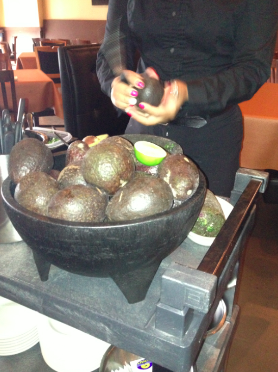 The staff at Gabriela's & Sofia's prepares guacamole, tableside
