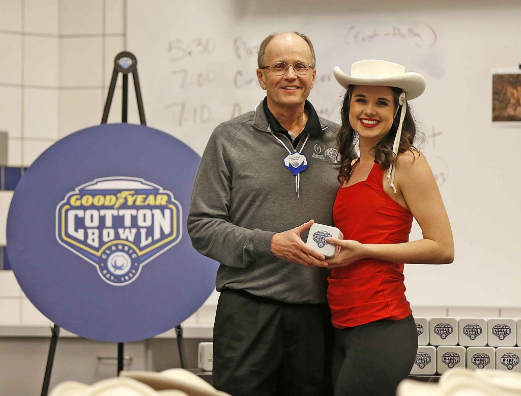 30 December 2015:    Bess Detar of the Kilgroe Rangerettes receives her Cotton Bowl watch from Charlie Fiss for the 2016 Goodyear Cotton Bowl Classic at AT&T Stadium in Arlington, Texas.   Photo by James D. Smith/CBAA