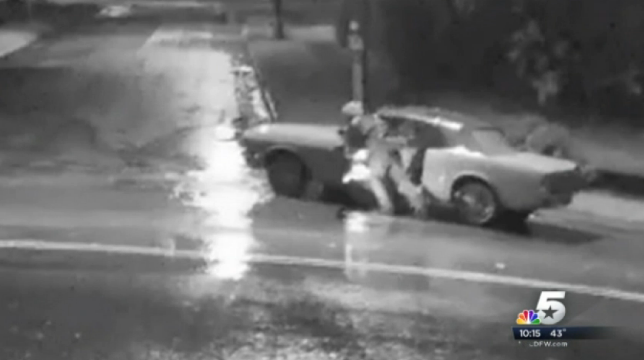 A screenshot of the security footage that shows a thief rolling a stolen 1965 Ford mustang down the street. 