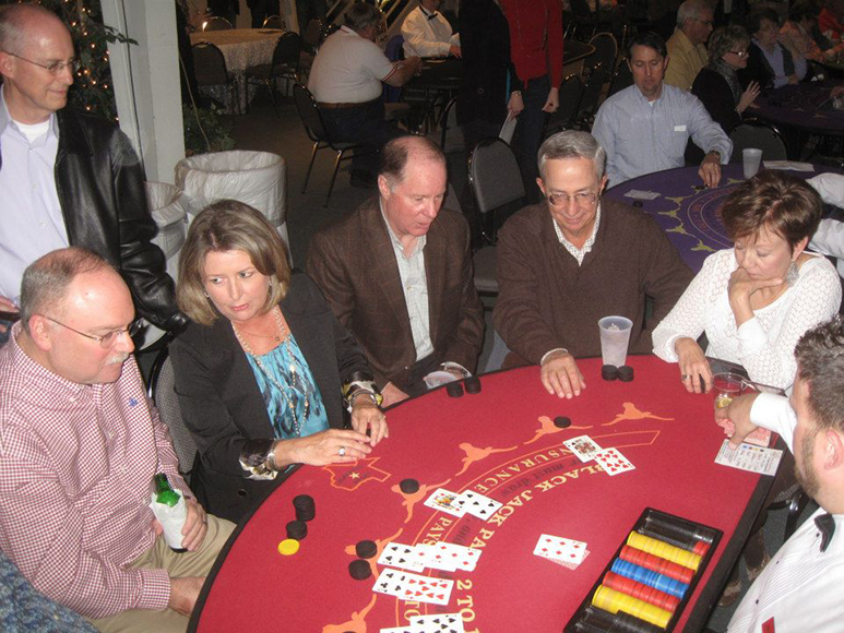 Karen Stutsman coaches David Solomon on blackjack at last year's Exchange Club casino party.
