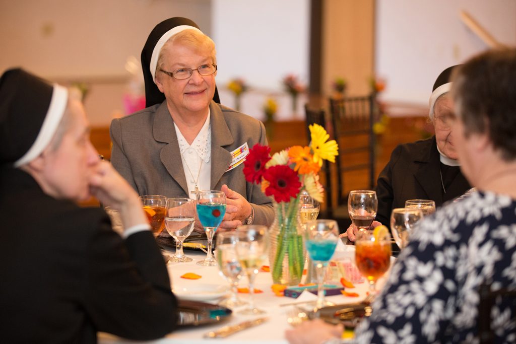 Senior Virginia Rozich converses with women from the Diocese of Dallas at the Kaycee Club. (Photo by Rasy Ran)