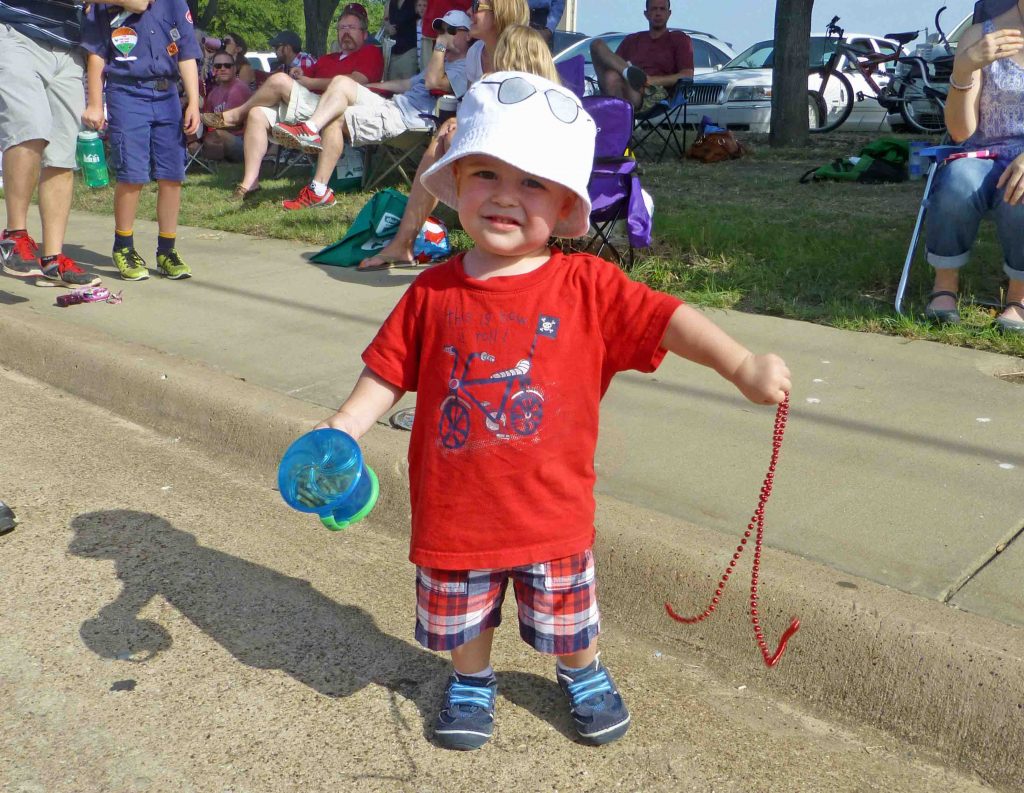 A boy enjoys the 2015 July 4th parade.