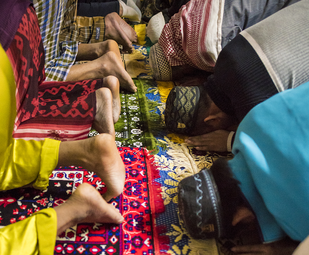 In a former storage unit, faithful Muslims pack in shoulder-to-shoulder for prayer five times a day, spilling over onto prayer mats in the parking lot. (Photo by Danny Fulgencio)