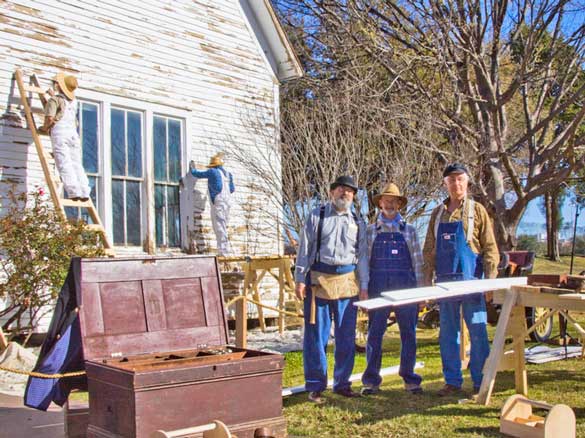 An old-timey construction crew worked to restore the  Pilot Grove Church.