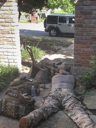 A neighborhood resident photographed a police sniper aiming at a Lake Highlands home in which a suspect had barricaded himself; she says police used her house as base during the day-long standoff: Savannah Askin