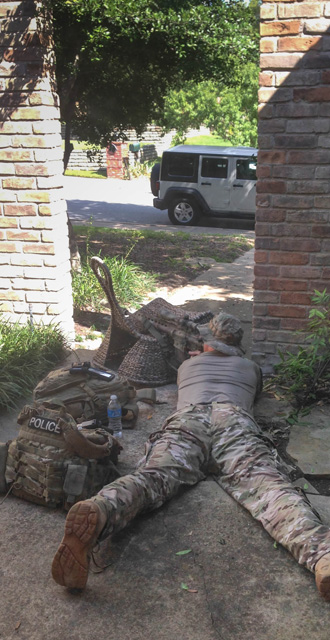 A neighborhood resident photographed a police sniper aiming at a Lake Highlands home in which a suspect had barricaded himself; she says police used her house as base during the day-long standoff: Savannah Askin