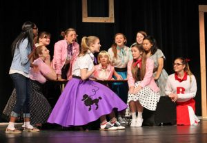 Kate Gavigan as Sandy tells of "Summer Lovin" in the LHHS production of Grease. Photo by Russ Aman.