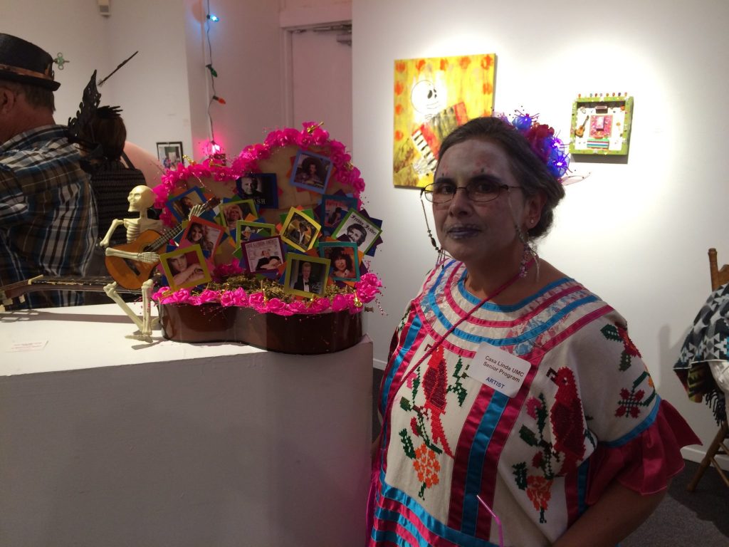 Casa Linda UMC senior program coordinator says that this mixed media piece, titled "La Musica por Dentro," means "the music inside." Seniors from the church program each included their favorite musicians in the piece. 