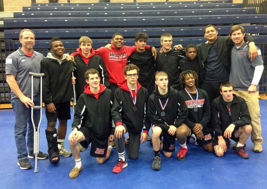 Pete Grieder (left in grey) with his wrestling team