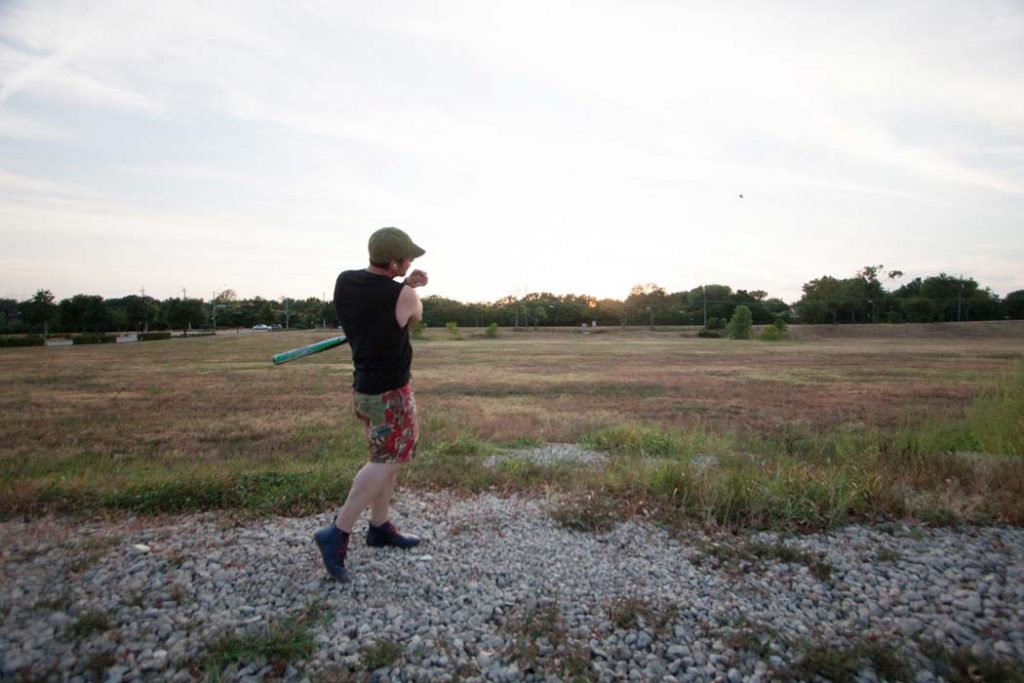 Lake Highlands resident Jacob Calvin bats rocks into the vacant lot of the proposed Lake Highlands Town Center. Calvin said some residents at the nearby Haven Apartment their home "the castle," due to being surrounded by its large unoccupied lot and main driveway. Photo by Rasy Ran