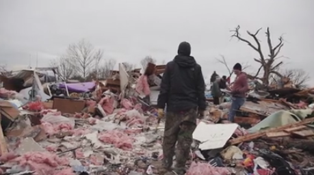 Volunteers help in a tornado-torn neighborhood. (Watermark video)