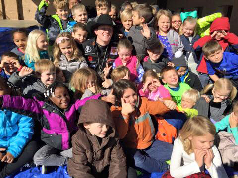 Cooper Davis surrounded by Moss Haven students