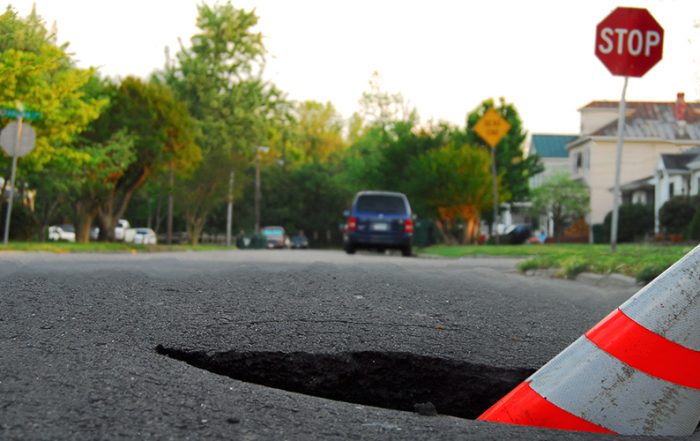 pothole with caution cone