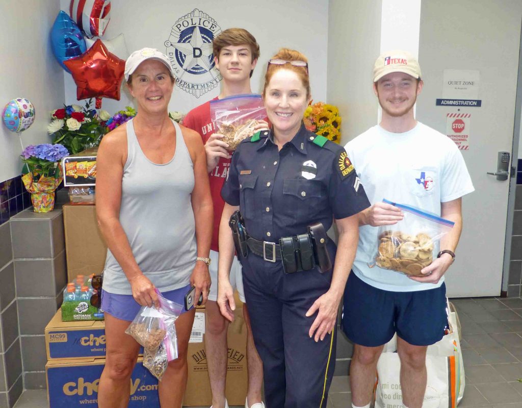 Tricia White, Jake White and Jared Denton deliver goodies from the Lake Highlands Women's League to Dallas Police