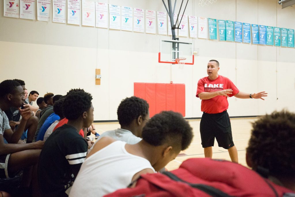 Joe Duffield, Lake Highlands High School Men’s Varsity Basketball Coach, runs through a midnight session at Lake Highland’s YMCA. The coach is one of the handful of volunteers, including Dallas Police Department officers from the PALS division, who are connecting with at-risk youth in a summer pilot basketball program. (Photo by Rasy Ran)