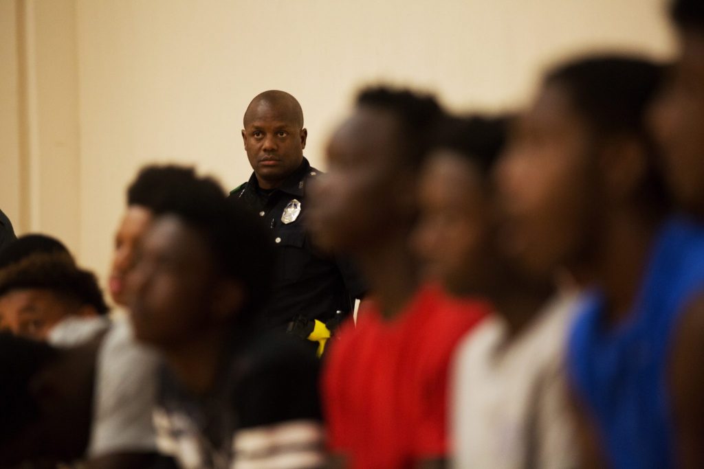 A DPD officer who volunteered his time spectates at the beginning of the last midnight basketball session at Lake Highland’s YMCA. (Photo by Rasy Ran)