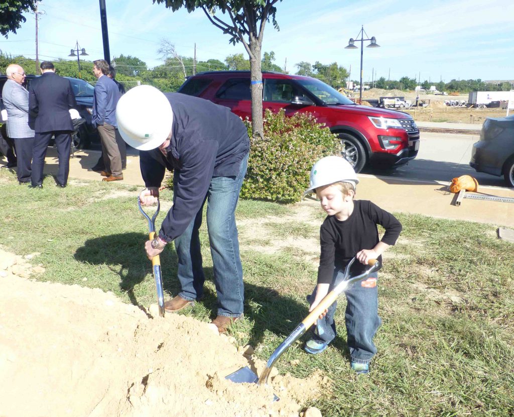 Eli McGough, son of Dallas City Councilman Adam McGough, tries his hand with the silver shovel.