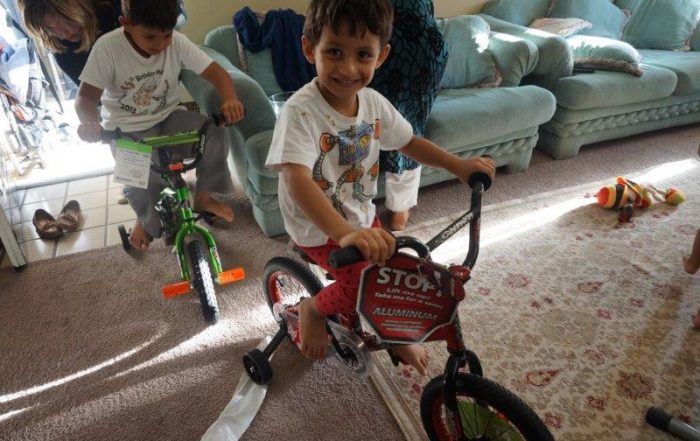 Young refugees revel in their newly gifted toys. (Photo from DFW International Community Alliance)