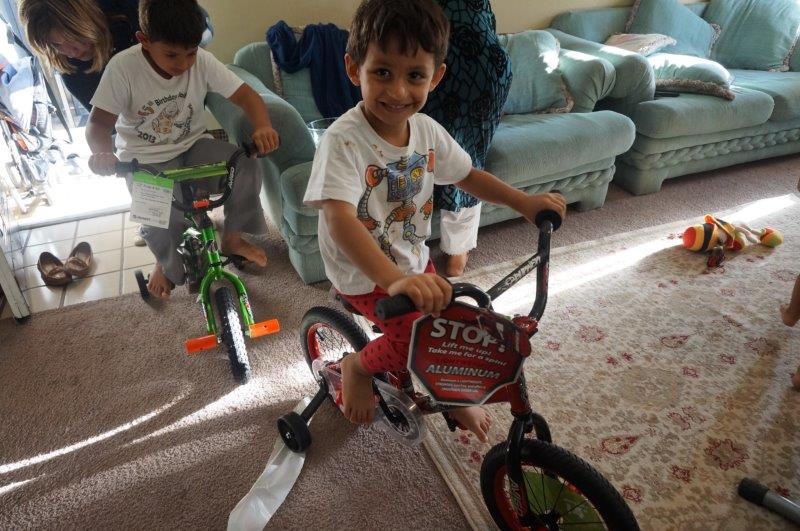 Young refugees revel in their newly gifted toys. (Photo from DFW International Community Alliance)