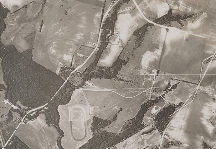 An aerial image taken by Lloyd M. Long between 1930-40, shows the outline of the doomed Hilltop Stables racetrack. (Edwin J. Foscue Map Library, Southern Methodist University) 