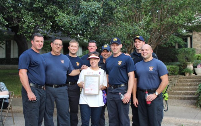 Joan Patmore, center, with a certificate of appreciation for the Northeast Division Patrol of the Dallas police.