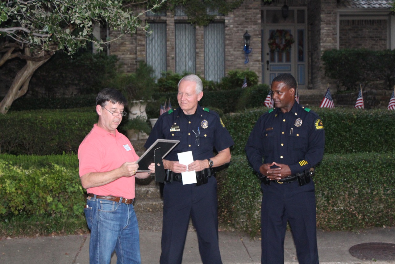Cheif Acord, center, accepts a donation from the Lake Highlands Square Neighborhood Association at National Night Out. (Photo by Amy Durant)