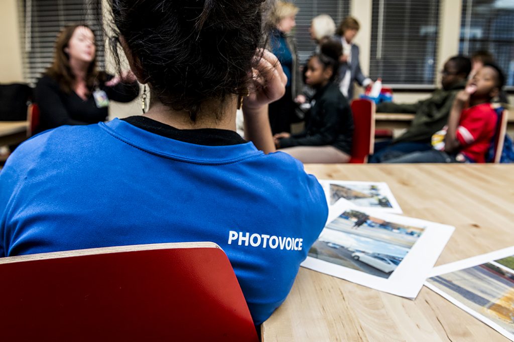 Volunteers teach students photography and social action through PhotoVoice. Photo by Danny Fulgencio