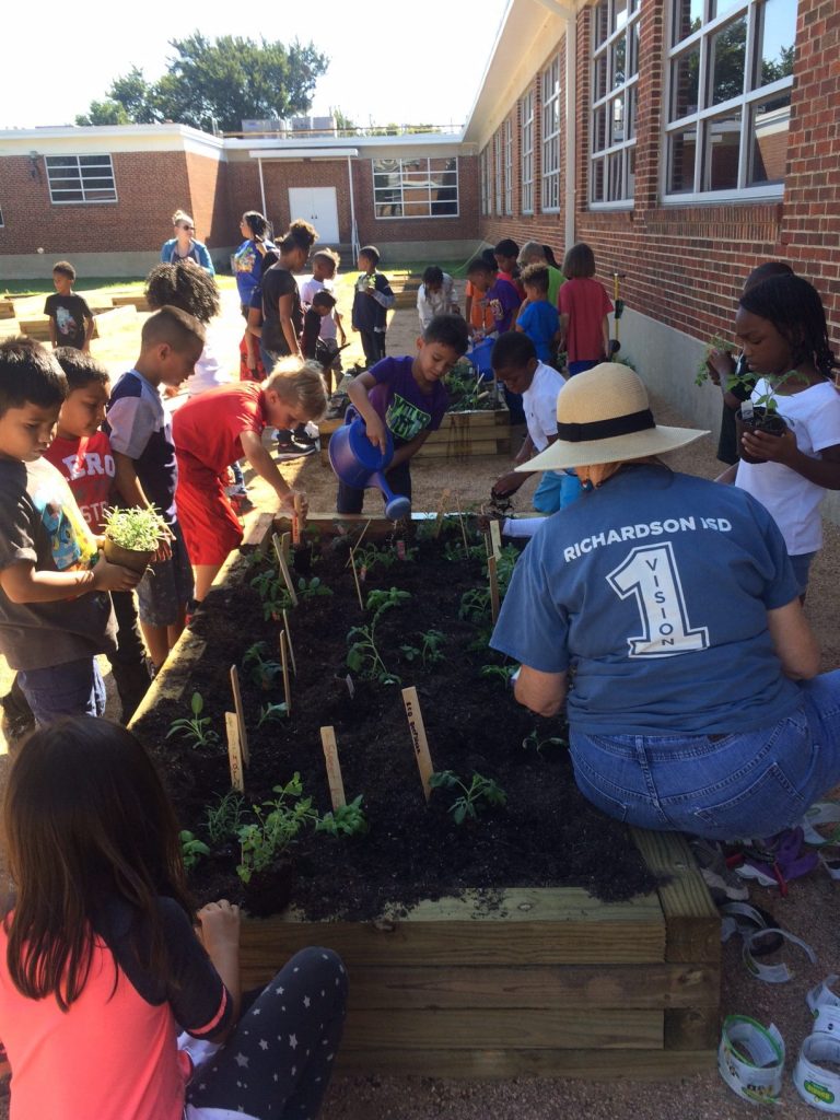 Students at Hamilton Park Pacesetter Magnet fill up their newly built garden classroom.