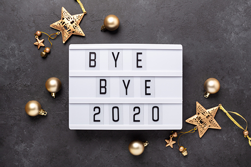 Lightbox with text BYE BYE 2020 with gold decoration on dark background. Top view. New year celebration. Happy New Year 2021 concepts - Image