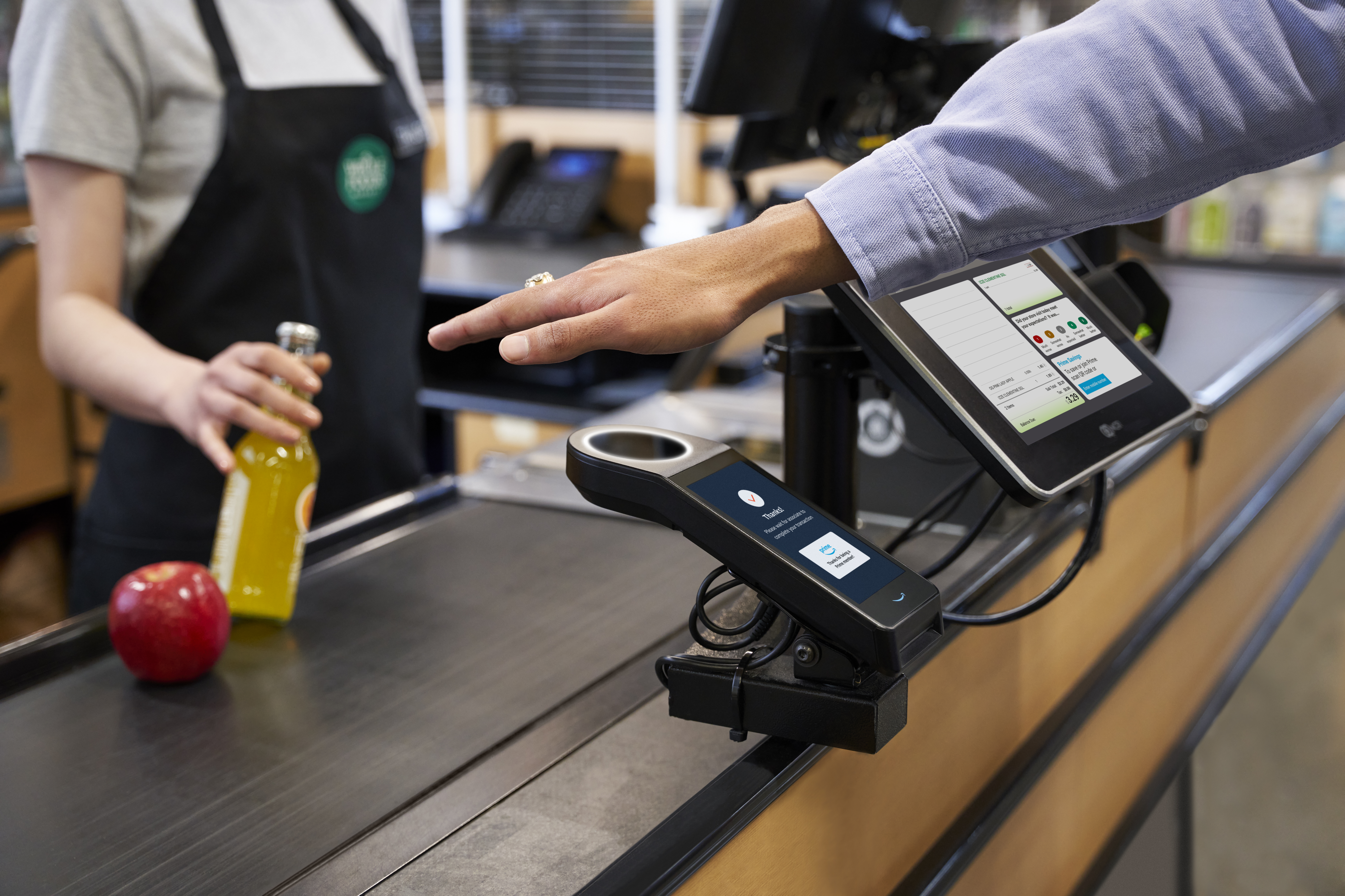 Person pays with palm at Whole Foods